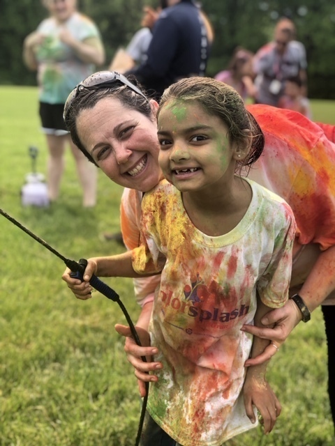 Mom and daughter with color sprayer posing