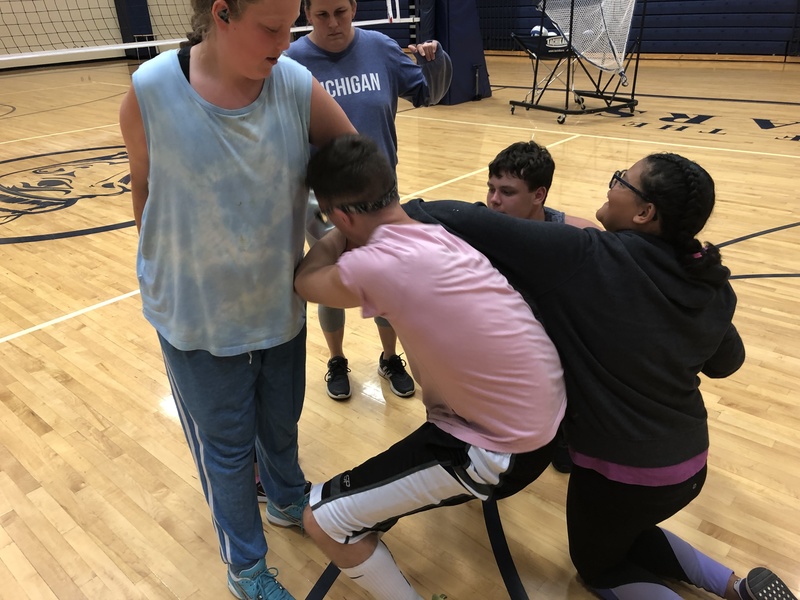5 students being coached by Sarah Ragnone on how to get their arms untwisted. 5 students being coached by Sarah Ragnone on how to get their arms untwisted.